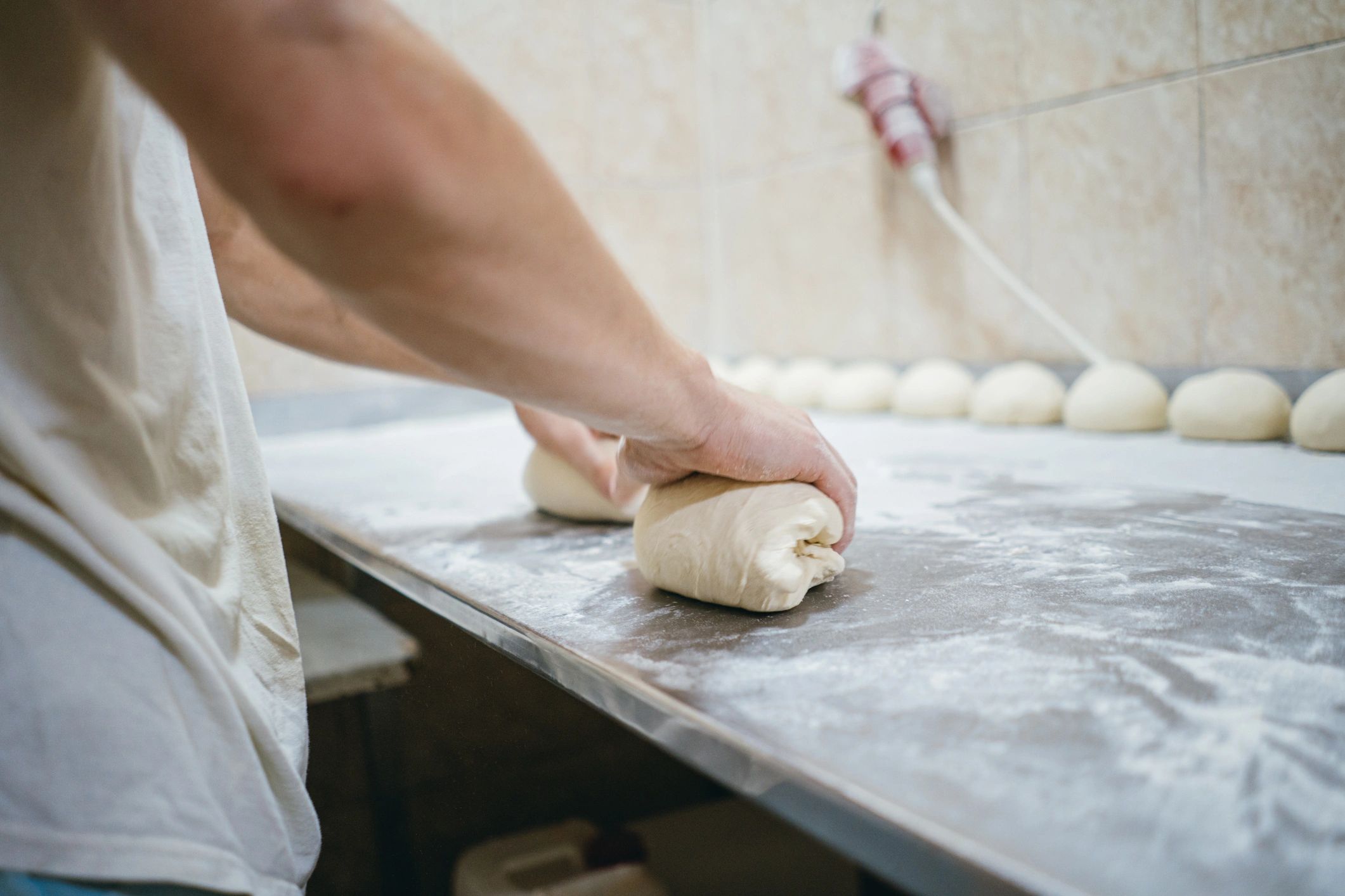 Baker preparing dough, representing bakery-grade flour applications